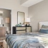 a bedroom with a bed and a mirror