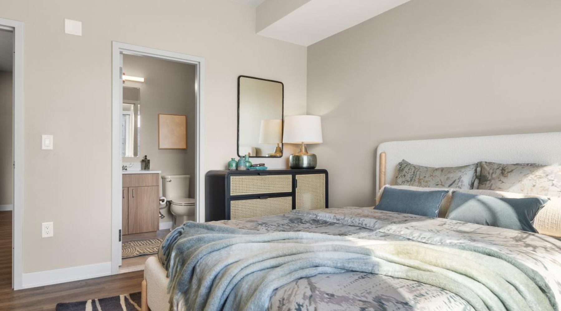 a bedroom with a bed and a mirror