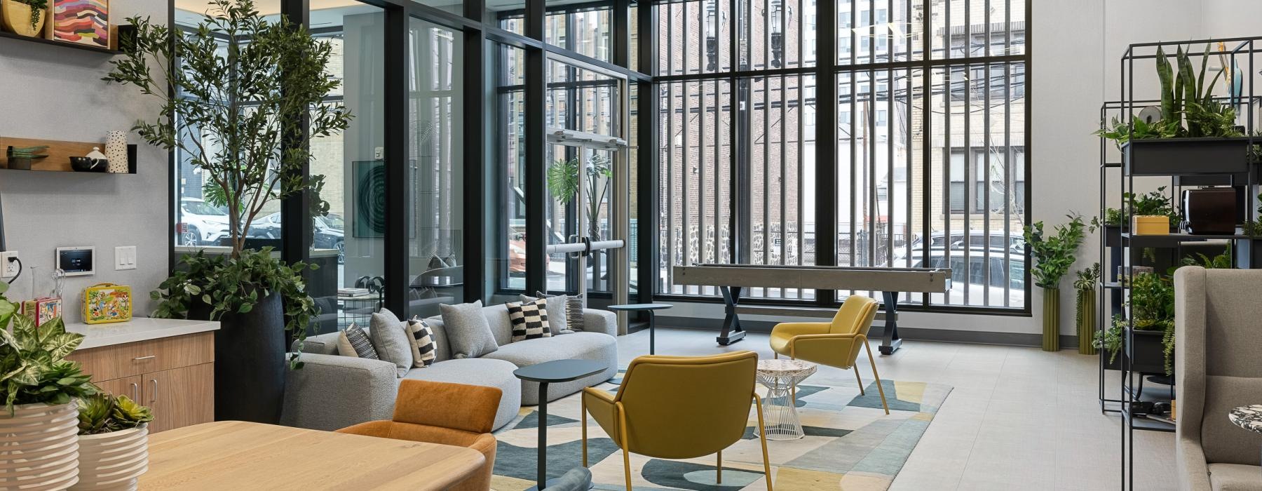 a room with a table chairs and a large window