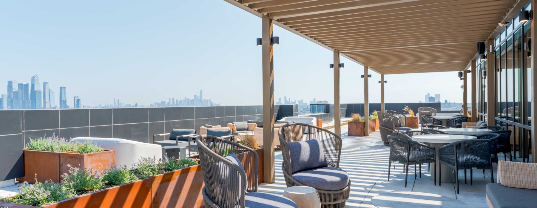 Outdoor terrace with lounge seating and NYC skyline views