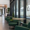 a room with green chairs and a table