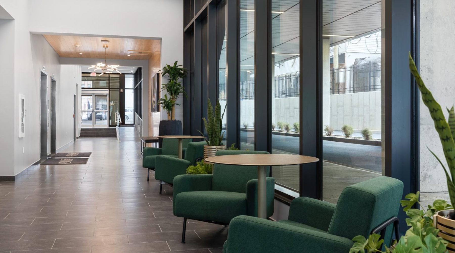 a room with green chairs and a table