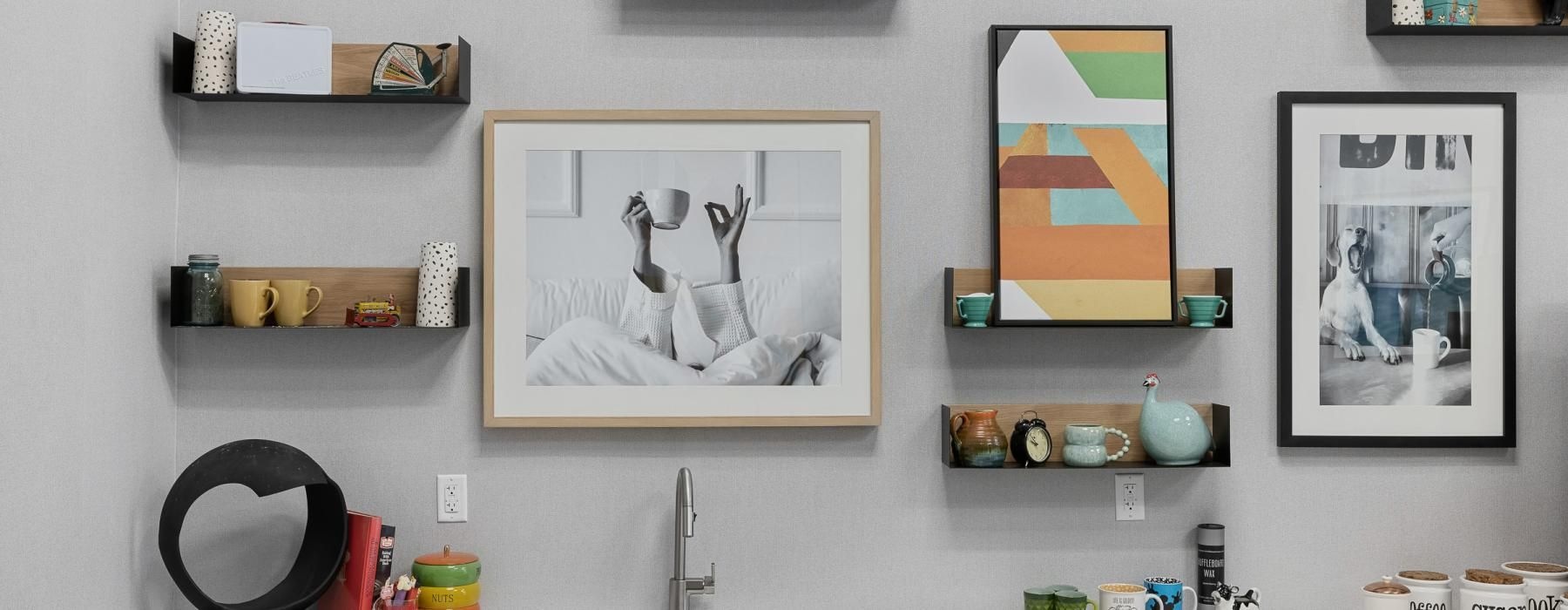 a kitchen with pictures on the wall