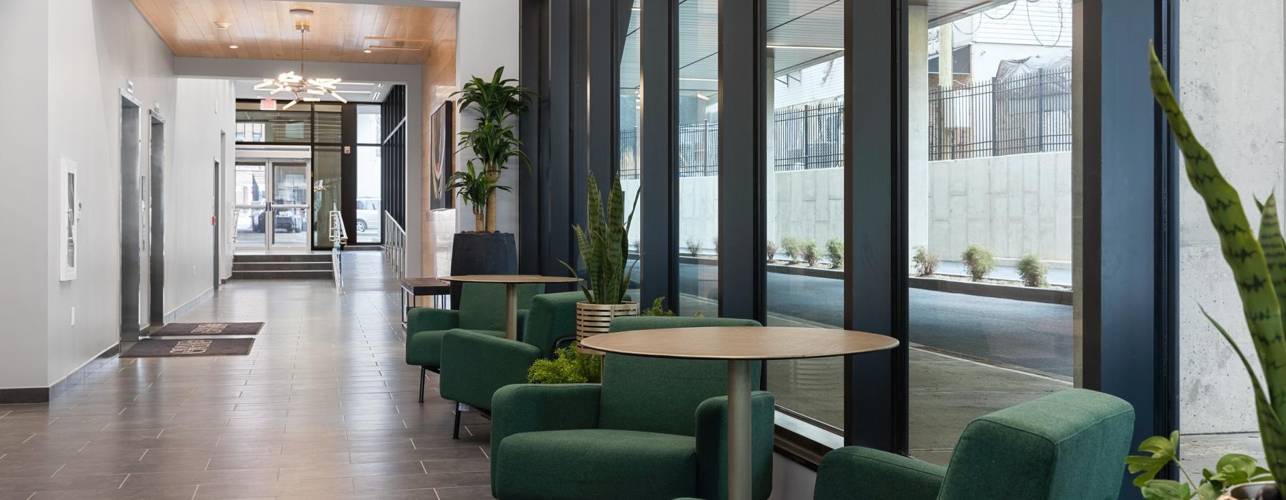a room with green chairs and a table